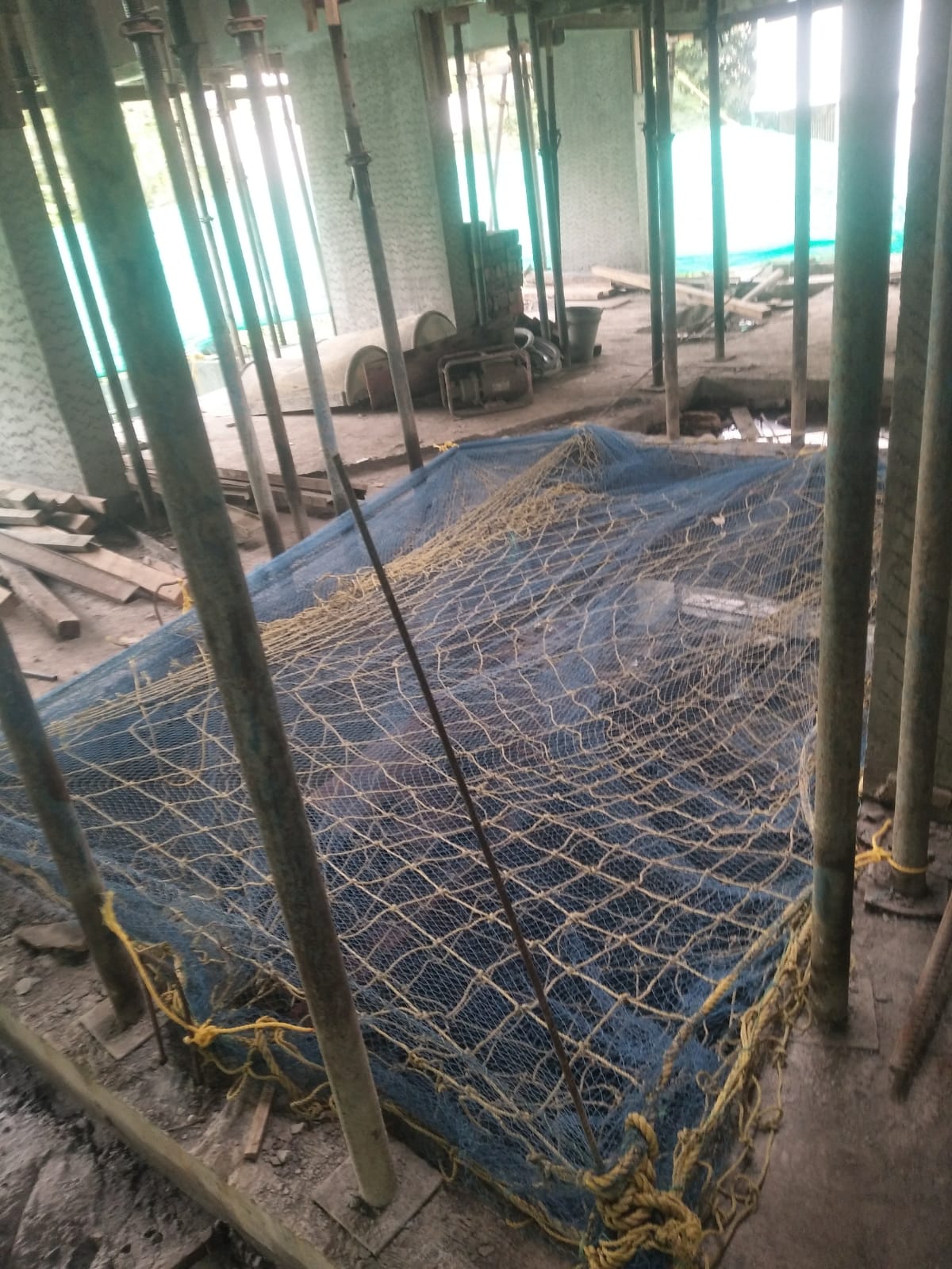 White safety net installed across a building balcony and open area