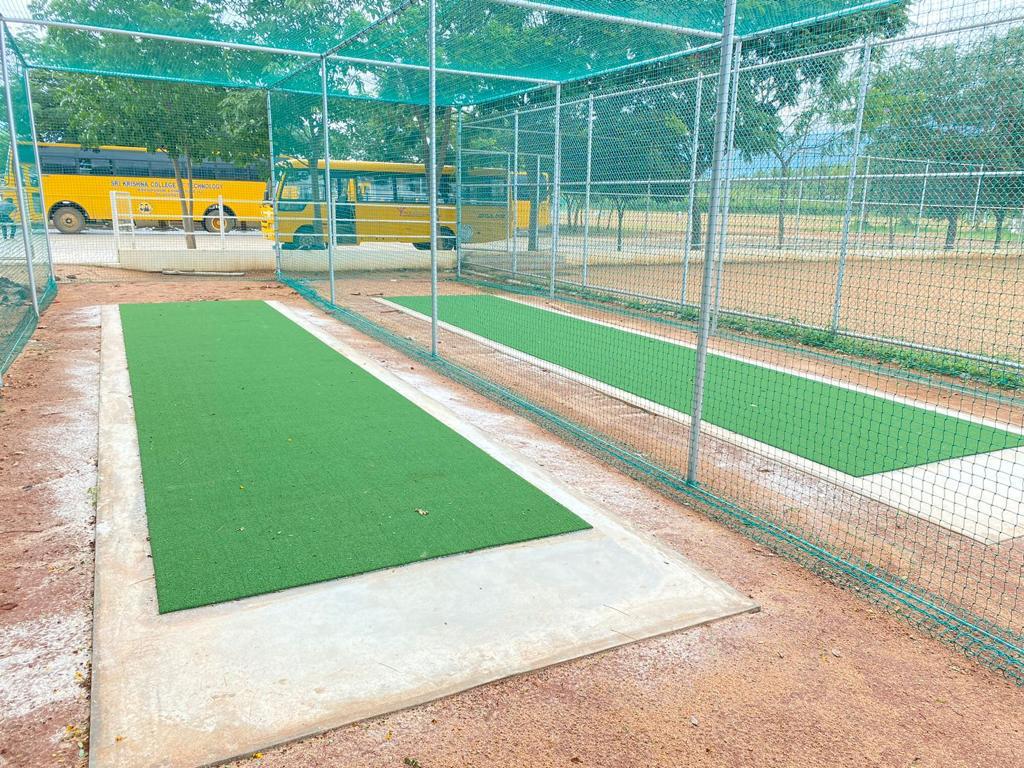 Cricket practice nets with artificial grass pitches installed at a college ground